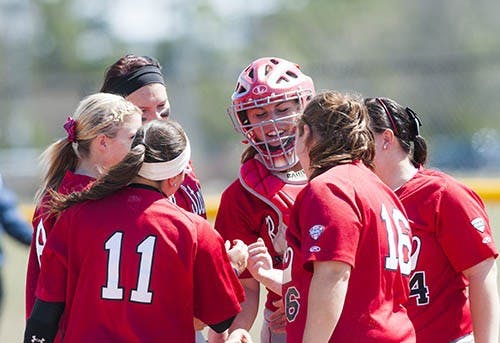 The softball team huddles on the pitchers mound during the game against Western Michigan on April 7. DN PHOTO JONATHAN MIKSANEK