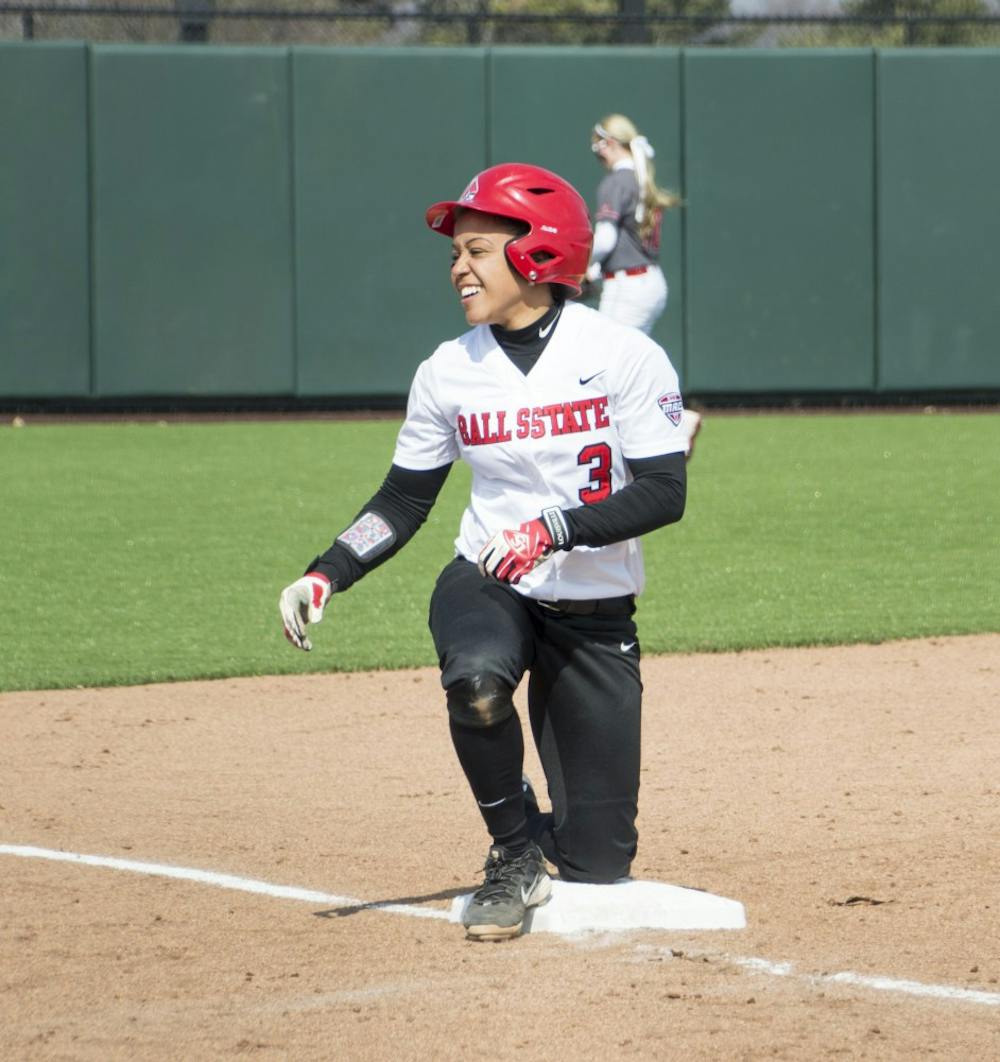 Senior catcher Jessica Craft smiles after sliding into third base during the first game of the double header against Western Kentucky at First Merchants Ballpark Complex on March 21. DN PHOTO ALAINA JAYE HALSEY