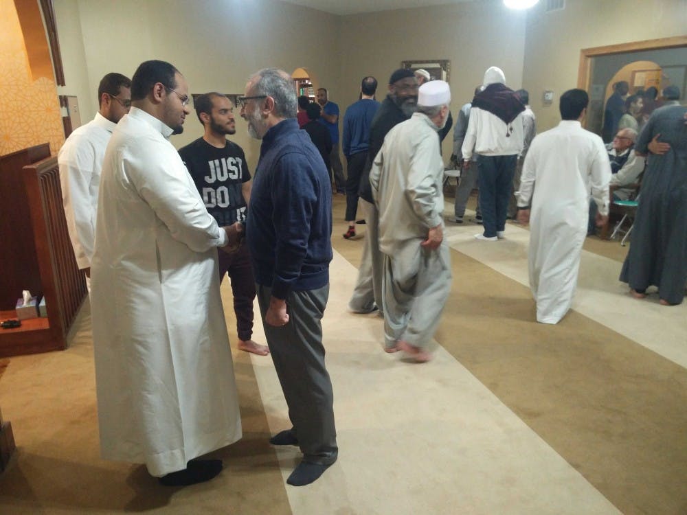 <p>(Left to right) Anas Almassrahy, graduate urban and regional planning major, greets a fellow worshipper after the prayers Sunday at the Islamic Center of Muncie. Ramadan in the United States began May 5, 2019, and will conclude June 4, 2019.<strong> Rohith Rao, DN</strong></p>
