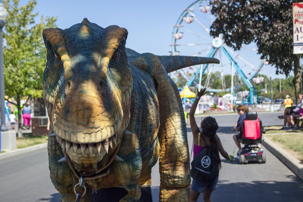 Rexy, an animatronic Tyrannosaurus res, roams the streets of the Indiana State Fair on Aug. 15. Rachel Brammer / BSU Journalism at the Fair
