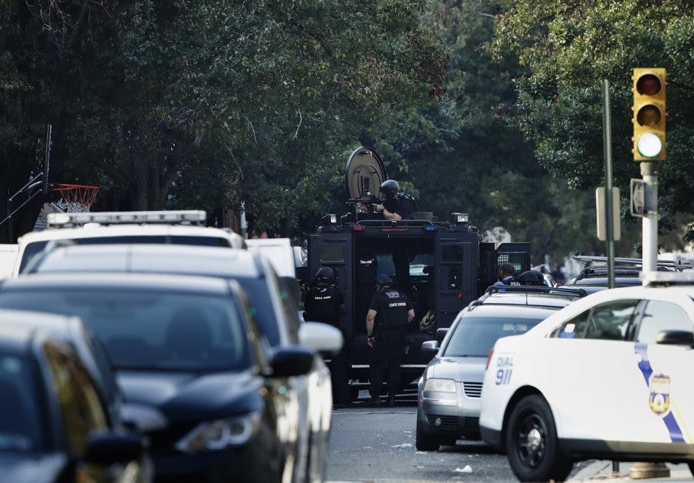 A massive police presence is set up outside a house as they investigate an active shooting situation, Wednesday, Aug. 14, 2019, in the Nicetown neighborhood of Philadelphia. (AP Photo/Matt Rourke)