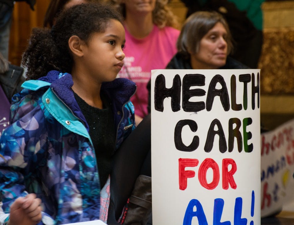 An attendee holds a sign at the Bernie Sanders Rally on Jan. 15 in the Indiana Statehouse. Kaiti Sullivan // DN