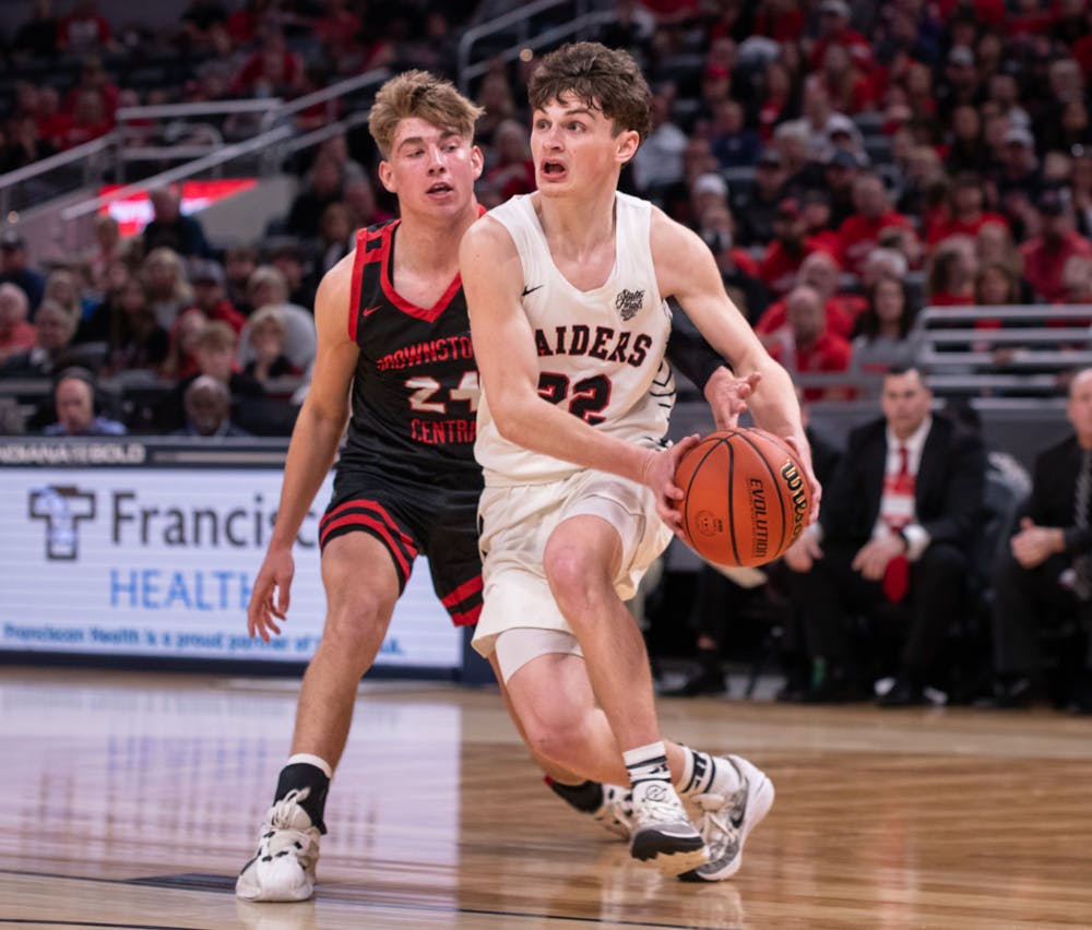 <p>Sophomore guard Camden Bell drives the ball against Brownstown Central March 30 at IHSAA State Finals at Gainbridge Fieldhouse in Indianapolis. Andrew Berger, DN</p>