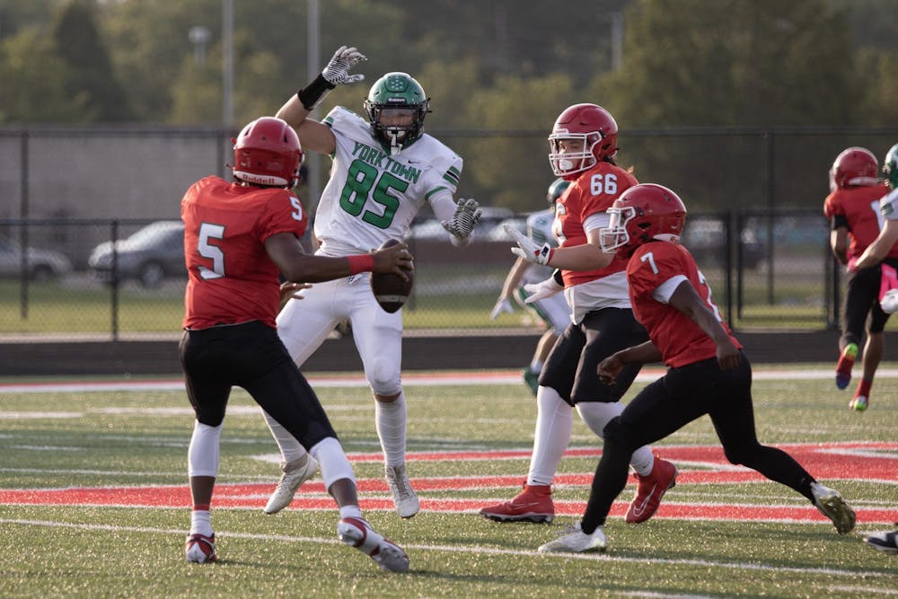 Yorktown senior tight end Julian Mckay attempts to block Anderson senior quarterback Damien King Aug. 24 during a game at Anderson High School. Payton Hammett, DN.