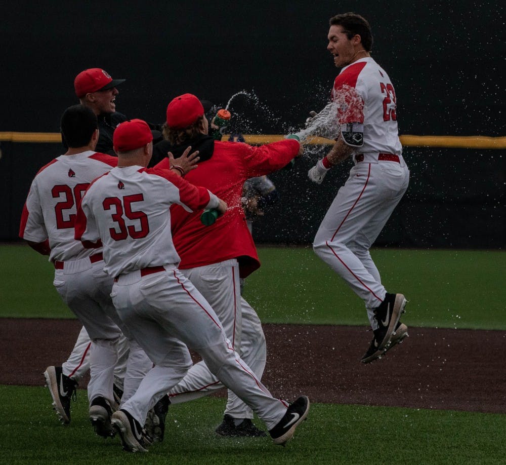<p>The Cardinals rush the field to meet then-junior Ross Messina after his game-winning hit against Kent State March 31, 2019, at Ball Diamond at First Merchants Ball Park Complex. The game went 13 innings before the Cardinals came out on top, 9-8. <strong>Rebecca Slezak, DN</strong></p>