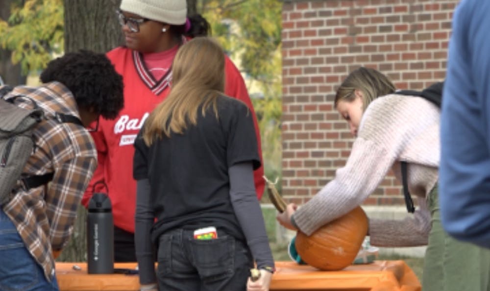 A group of students write the things they are stressed about on a pumpkin while talking with success coaches.
Shaylee Milom, NewsLink Indiana