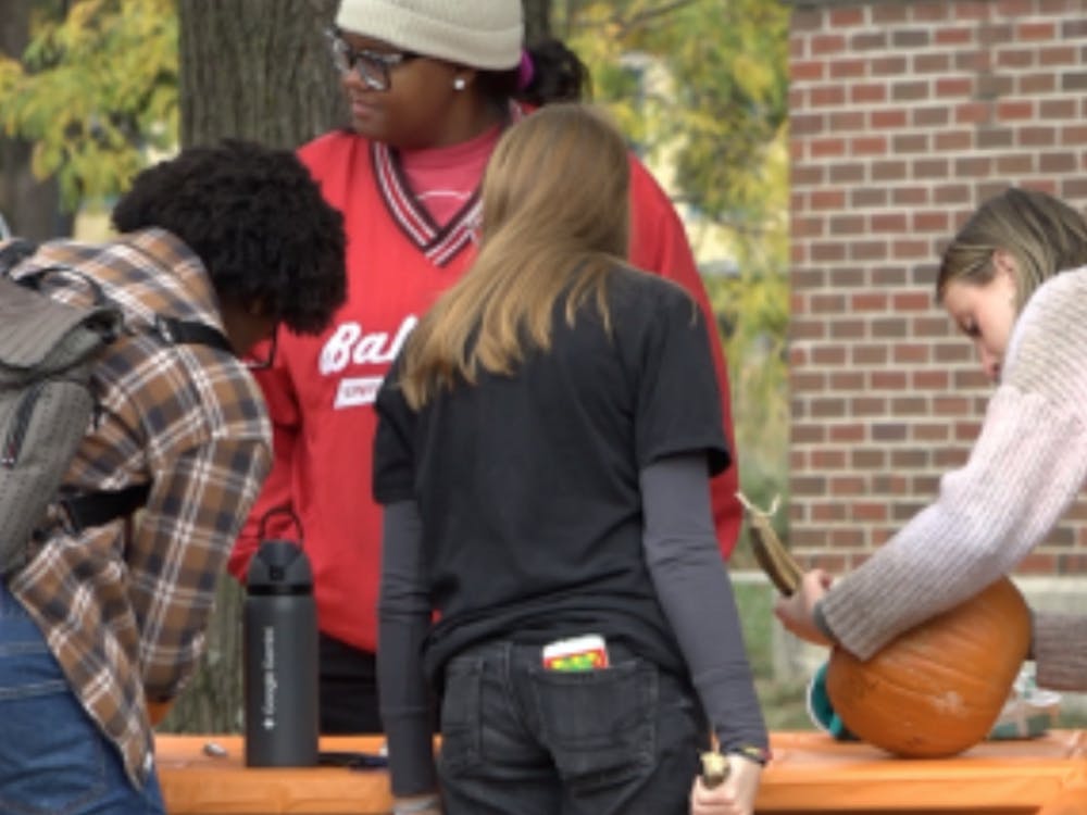 A group of students write the things they are stressed about on a pumpkin while talking with success coaches.
Shaylee Milom, NewsLink Indiana