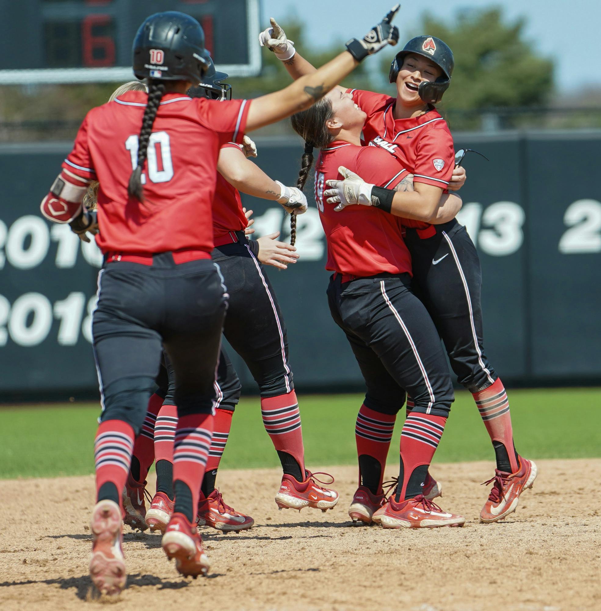 Ball State players celebrate after fifth-year utility player Amelia Daniel hits a walk-off single to win the game in a game against Central Michigan March 26 at the Softball Field at First Merchant Ballpark Complex. Daniel's RBI in the game was the game winning run. Brayden Goins, DN