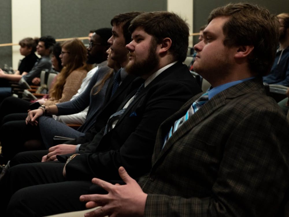 Jake Biller, presidential candidate for the United slate, and Andy Hoffman, campaign manager for the United slate, listen to a speaker Feb. 12, 2019 during the Student Government Association nomination convention in the Arts and Journalism building. &nbsp;United was one of the three slates nominated. Scott Fleener, DN