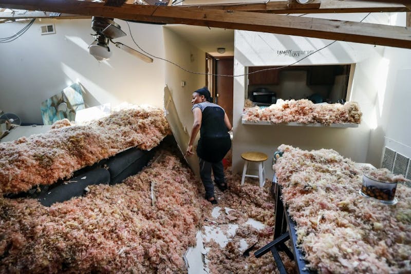 Erica Bohannon leads reporters through her destroyed apartment, Tuesday, May 28, 2019, in Trotwood, Ohio, after a tornado storm system passed through the area the night before, tearing her roof off while she huddled with her son and dog in her bedroom closet. (AP Photo/John Minchillo)