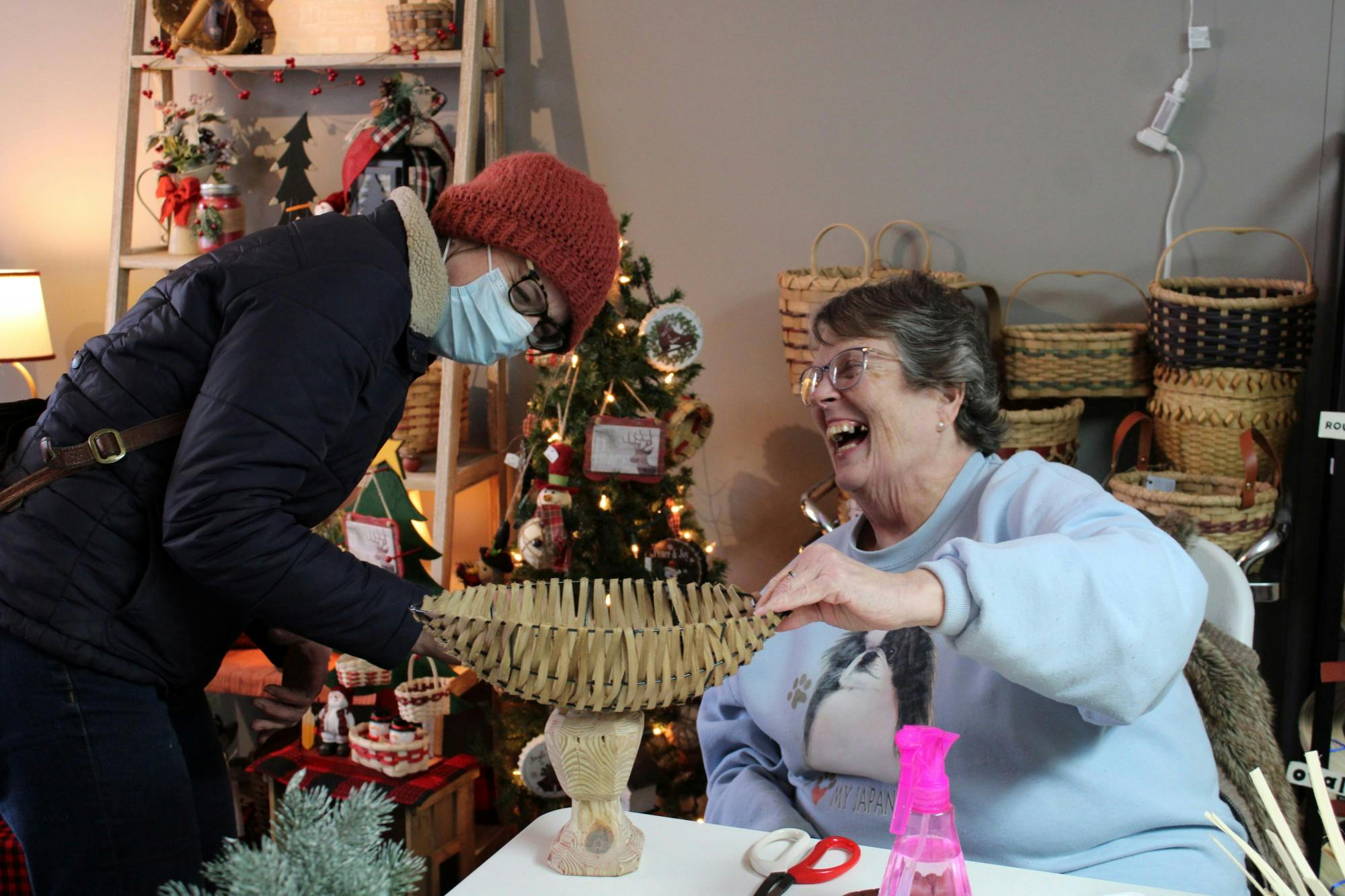 Second Year Grad Sculpture Student Ellen Leigh (left) gives Sandy Tharp (right) a mount that she sculpted for Tharp to put the basket on top of on Jan. 14, 2022 at Forever Baskets in Muncie, IN. Amber Pietz, DN