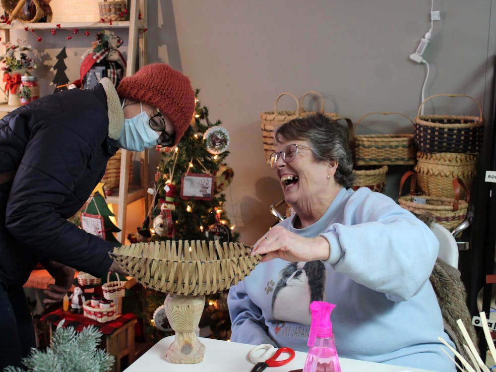 Second Year Grad Sculpture Student Ellen Leigh (left) gives Sandy Tharp (right) a mount that she sculpted for Tharp to put the basket on top of on Jan. 14, 2022 at Forever Baskets in Muncie, IN. Amber Pietz, DN