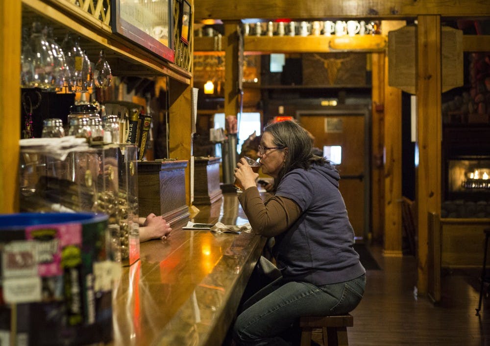 <p>The Heorot Pub and Draught House in downtown Muncie sits quietly with a few customers and a bartender serving a wide selection of craft beer to the Muncie residents April 4.<strong> Grace Hollars, DN</strong></p>