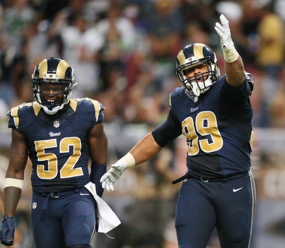 St. Louis Rams defensive tackle Aaron Donald, right, celebrates after sacking Seattle Seahawks quarterback Russell Wilson for a 4-yard loss on third down in the third quarter on Sunday, Sept. 13, 2015, at the Edward Jones Dome in St. Louis. The Rams won, 34-31. (Chris Lee/St. Louis Post-Dispatch/TNS)