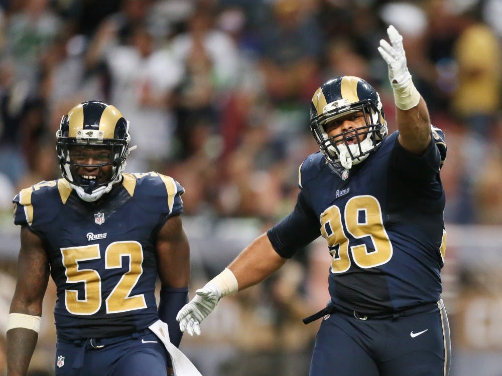 St. Louis Rams defensive tackle Aaron Donald, right, celebrates after sacking Seattle Seahawks quarterback Russell Wilson for a 4-yard loss on third down in the third quarter on Sunday, Sept. 13, 2015, at the Edward Jones Dome in St. Louis. The Rams won, 34-31. (Chris Lee/St. Louis Post-Dispatch/TNS)
