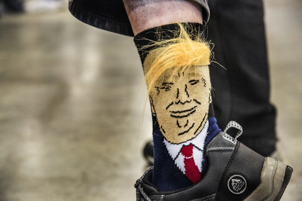 An older supporter of the 2016 presidential candidate shouted to look at his socks to a small group of news reporters, lifting his pant leg to reveal the socks he had purchased online only a week before the rally in Indianapolis. DN PHOTO TRENT SCROGGINS