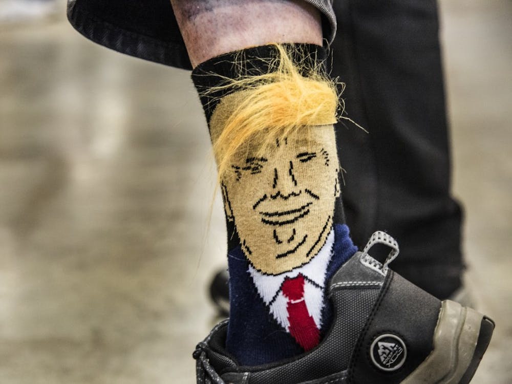 An older supporter of the 2016 presidential candidate shouted to look at his socks to a small group of news reporters, lifting his pant leg to reveal the socks he had purchased online only a week before the rally in Indianapolis. DN PHOTO TRENT SCROGGINS