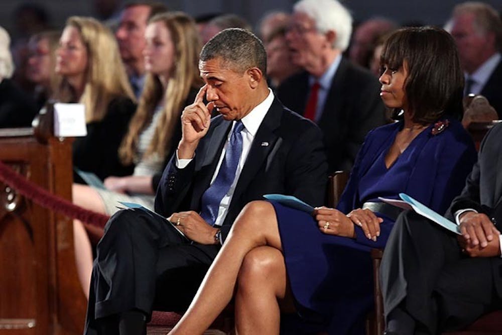 President Barack Obama and first lady Michelle Obama attend an interfaith prayer service for victims of the Boston Marathon attack titled &quot;Healing Our City,&quot; at the Cathedral of the Holy Cross, Thursday, April 18, 2013 in Boston, Massachusetts. (Pool photo by Spencer Platt/Getty Images/MCT)