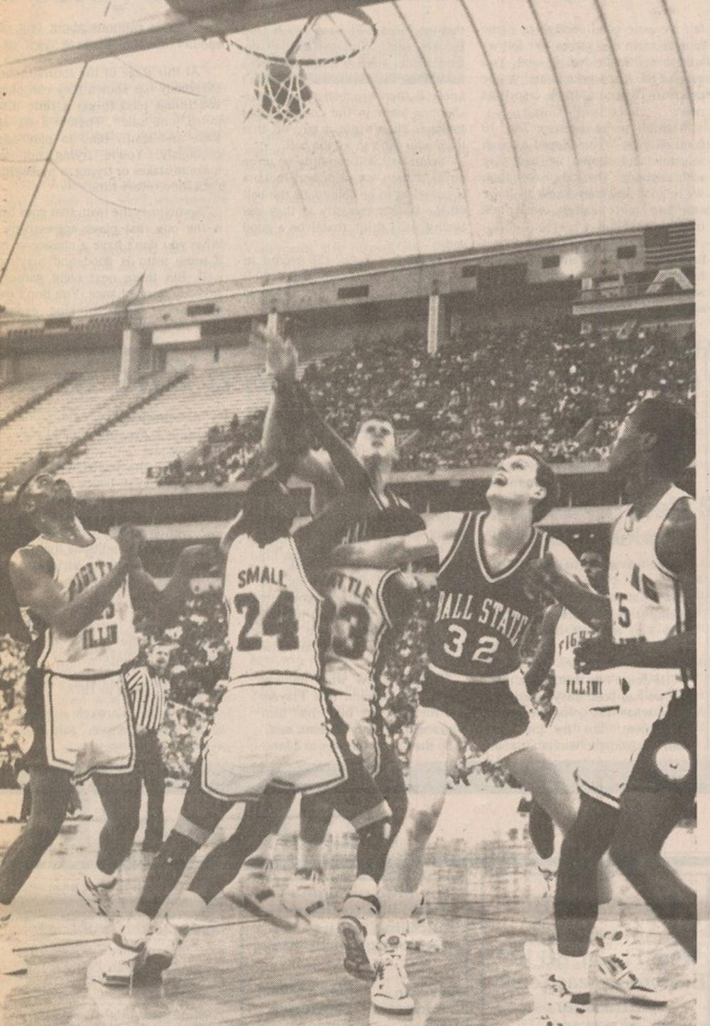 <p>Greg Miller puts up a shot as Roman Muller fights for rebounding position in a 1989 game. Miller and Muller were two of nine seniors on the 1990 team that went to the Sweet 16. This photo was printed in the March 21, 1989 Daily News edition.</p>