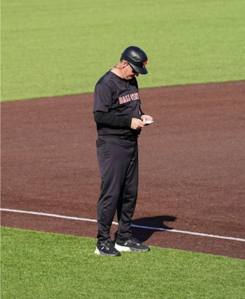 Rich Maloney coaching third base.