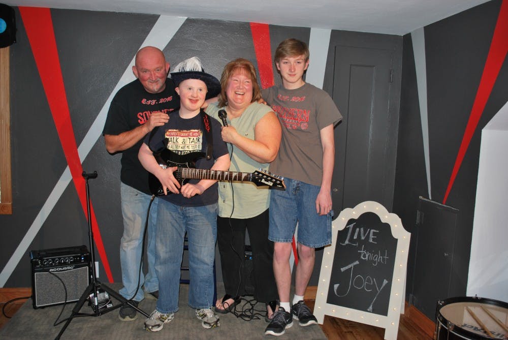 <p>Joey Stover, recipient of the first room remodeled by Dream Nest, smiles with his family after seeing his remodeled bedroom. Peggy Fisher // Photo provided</p>