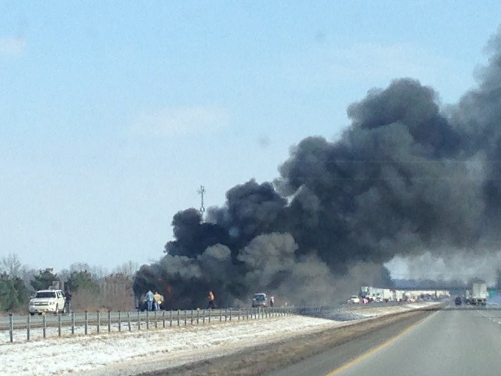 	Smoke from a burning Ball State bus rolls across Interstate 69, north of Indianapolis. DN PHOTO MARIA STRAUSS