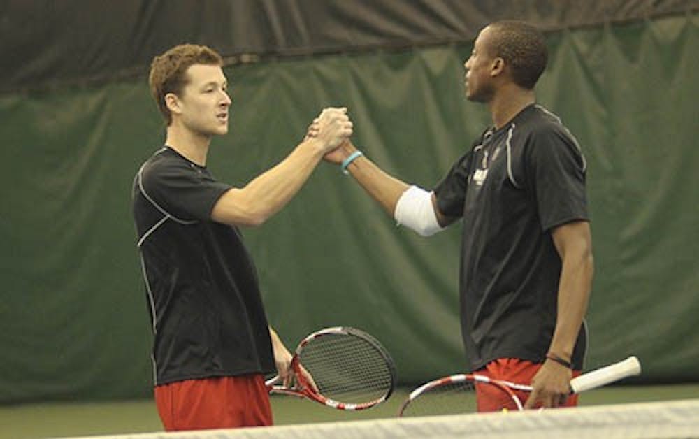 Dalton Albertin and Alexandre Brym shake hands after the match March 17, 2013 against Xavier. Albertin took both his doubles and his singles match with the team winning the match 4-3. PHOTO PROVIDED BY ALI MERCADO