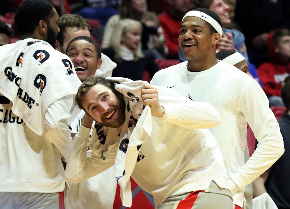 <p>Ball State junior guard Ishmael El-Amin, redshirt junior forward Brachen Hazen and redshirt freshman guard Jarron Coleman celebrate redshirt sophomore forward Miryne Thomas dunking during the Cardinals' game against Howard Saturday, Nov. 23, 2019, at John E. Worthen Arena. Ball State won 100-69. <strong>Paige Grider, DN</strong></p>