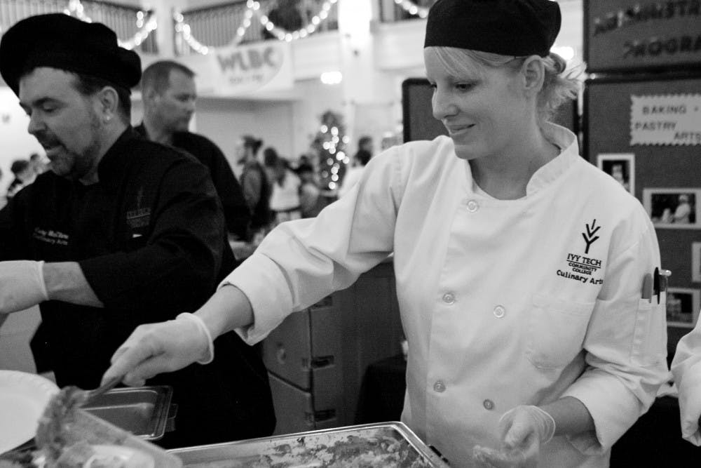 IVY Tech Student Alisha Mosier serves a dish made by students during the annual Taste of Muncie on Sunday the 21st.  Twenty two organizations that had booths with food for tasting at the Cornerstone Center of the Arts building downtown.  DN PHOTO JORDAN HUFFER