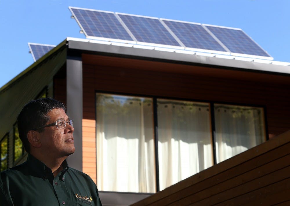 Mouli Vaidhyanathan, president of Mouli Engineering, stands in front of a home in St. Paul, Minnesota, where the homeowner had installed two of his company’s SolarPod panels. Indiana has nearly doubled its solar industry. MCT PHOTO