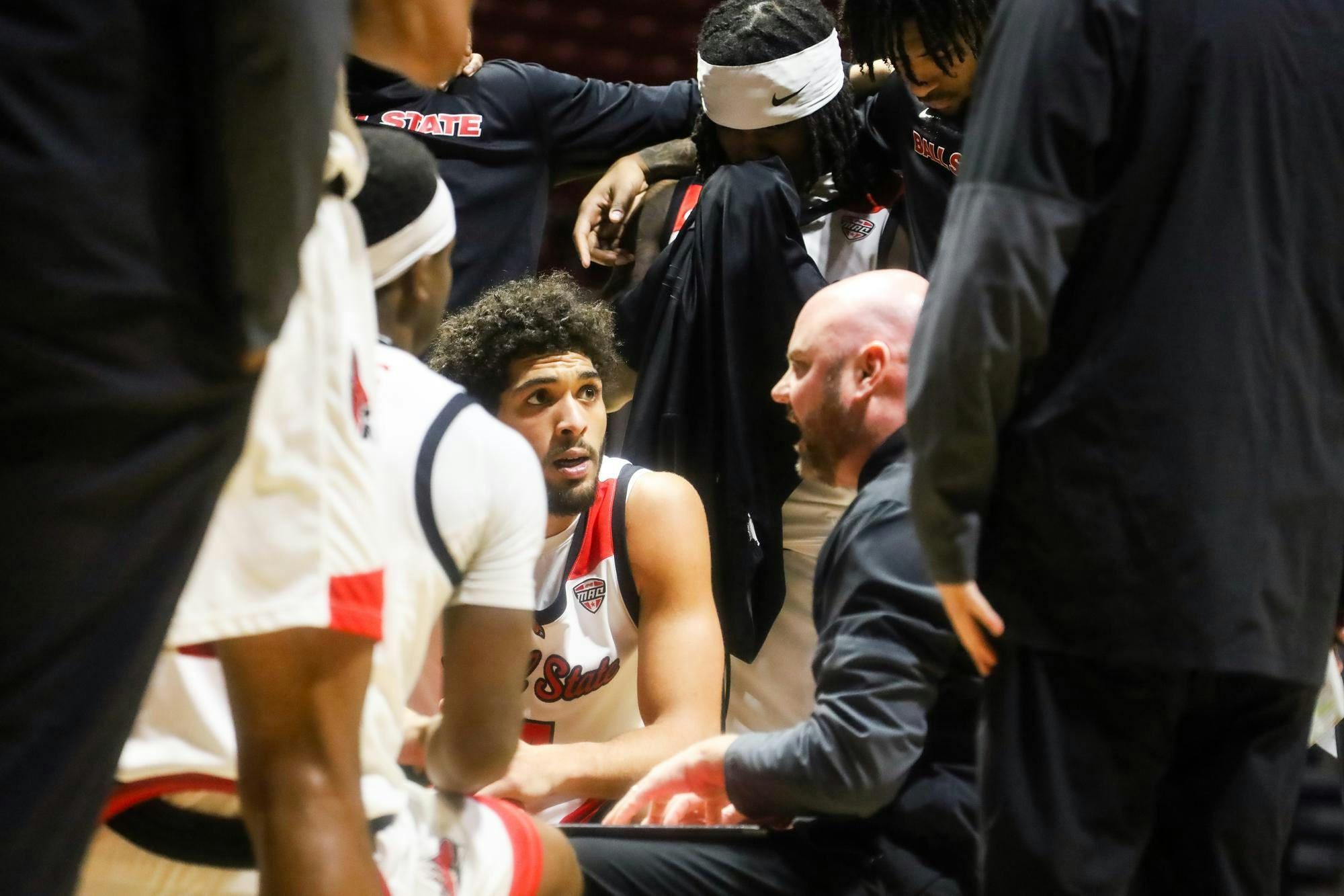 Players listening to head coach Michael Lewis at the game against NIU Jan. 24 at Worthern Arena. Mallory Hall, DN