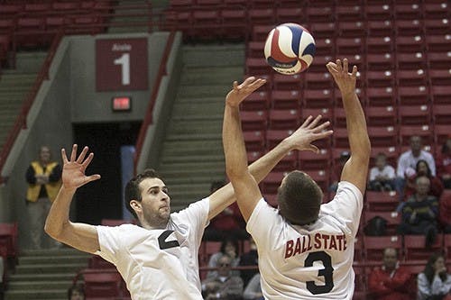 Junior Middle Attacker Matt Leske and Senior Setter Dan Wishmann play during the game on Saturday afternoon. The men's volleyball team won the match, three sets to two against Canyon. DN PHOTO JORDAN 