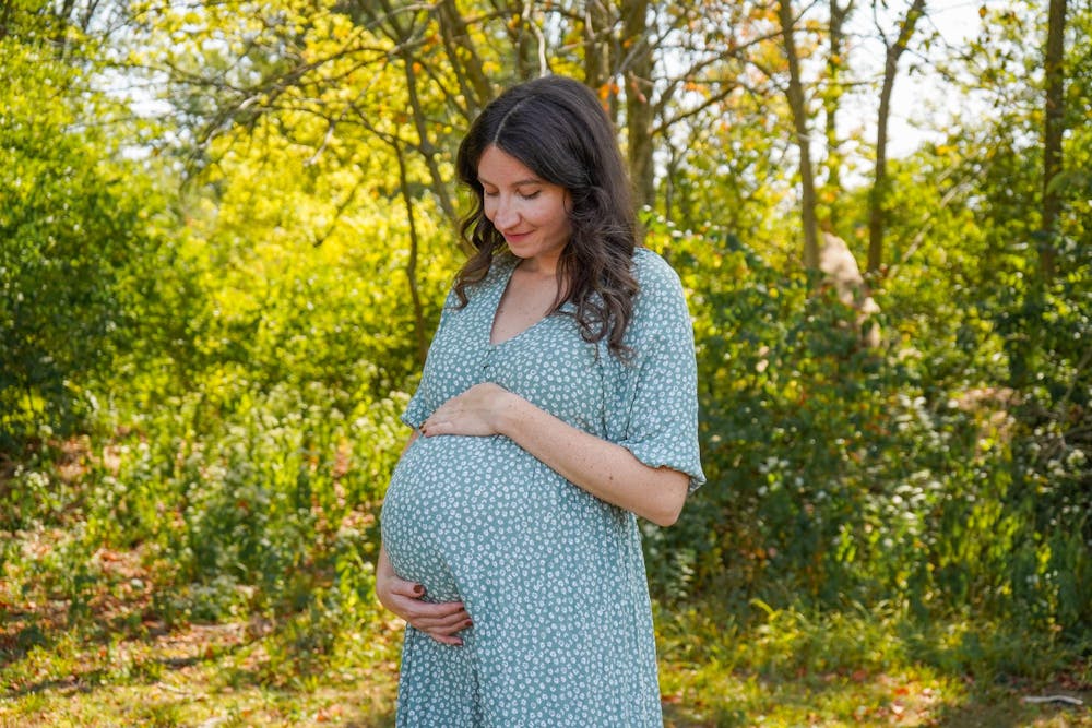 Lea Watson holds her bump for a photo Sept. 11 in Yorktown. Watson is currently pregnant for the fourth time with her third child. Isabella Kemper, DN