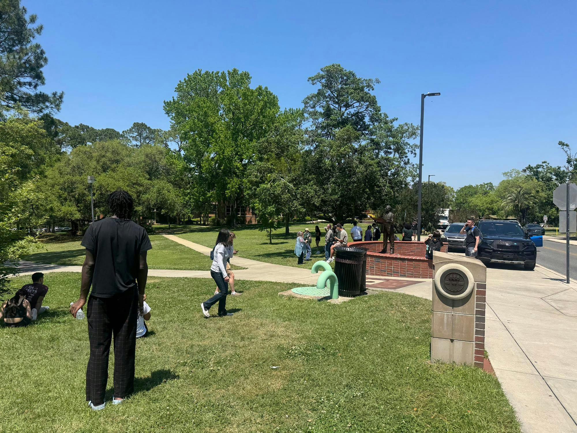 Florida State University students and faculty members wait in a grassy area near the student union where the active shooting was reported. Ana Ceballos/Miami Herald/TNS