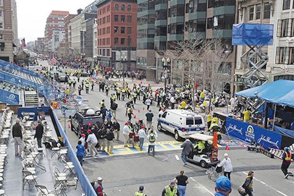 Emergency personnel assist victims at the scene of a bomb blast during the Boston Marathon on April 15, 2013. As of April 16, 2013, authorities didn’t know who was responsible for the explosions. MCT PHOTO
