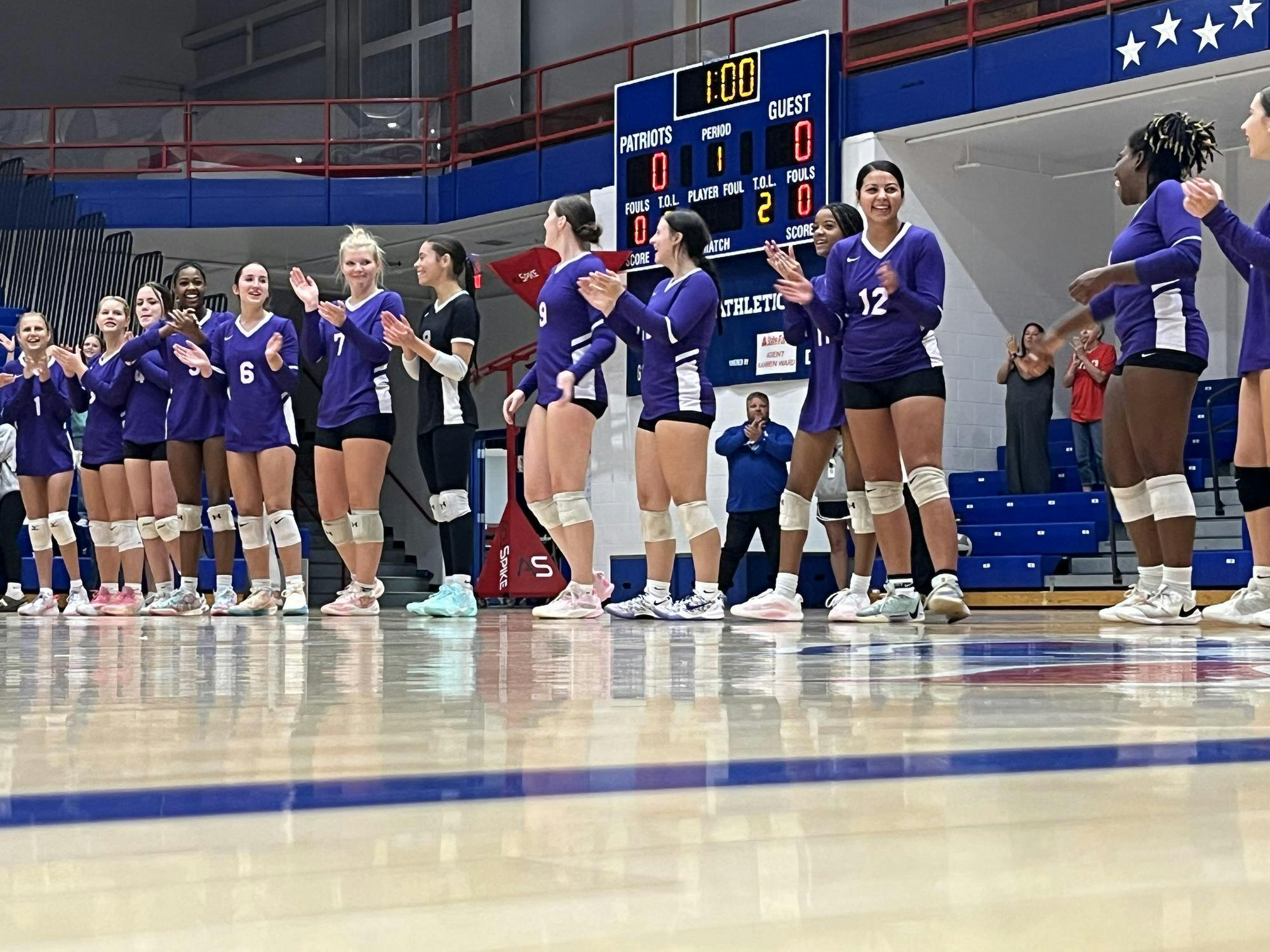 The Muncie Central Lady Bearcats’ varsity team stands in a line as they prepare to take on the Jay County Lady Patriots. The team lost all three matches in the set. Photo by Evan Shotts.