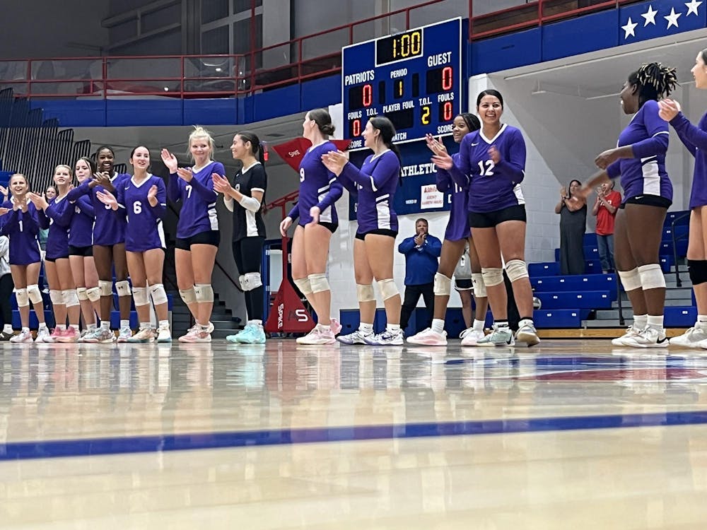 The Muncie Central Lady Bearcats’ varsity team stands in a line as they prepare to take on the Jay County Lady Patriots. The team lost all three matches in the set. Photo by Evan Shotts.