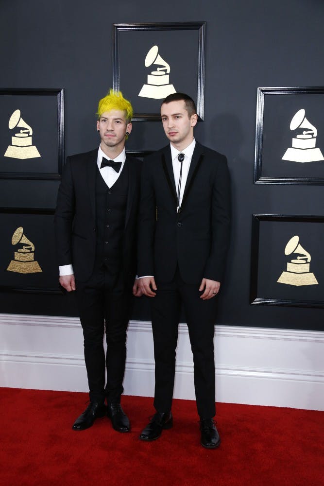Josh Dunn, left, and Tyler Joseph of Twenty One Pilots arrive at the 59th Annual Grammy Awards at Staples Center on Feb. 12.  A Grammy was awarded to 21 Pilots for their song “Stressed Out”. TNS Photo