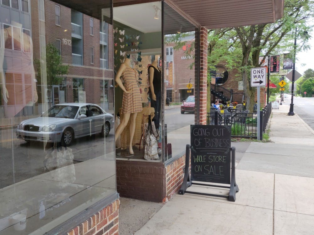 <p>A sign outside the Juniper store promotes a sale May 31, 2019, in the Village. The owners of the store will be selling the store by July, when their lease expires. <strong>Rohith Rao, DN</strong></p>