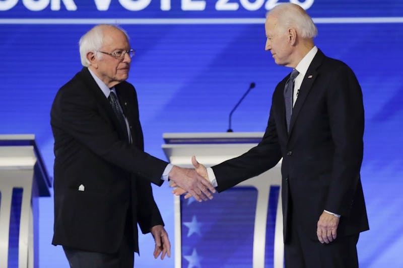 Democratic presidential candidates Sen. Bernie Sanders, I-Vt., left, and former Vice President Joe Biden, shake hands on stage Friday, Feb. 7, 2020, before the start of a Democratic presidential primary debate hosted by ABC News, Apple News, and WMUR-TV at Saint Anselm College in Manchester, N.H. (AP Photo/Charles Krupa)