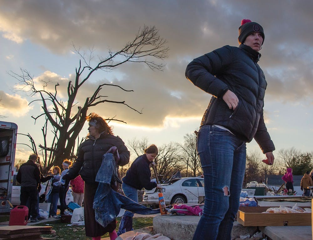 Volunteers and residents continue to shovel debris and gather anything salvageable from one of several destroyed homes near Home Ave. in Kokomo, Ind. DN PHOTO COREY OHLENKAMP