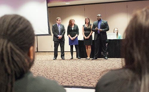 Cardinal United's presidential candidate Zeyne Guzeldereli, vice presidential candidate Alexa Gates, secretary candidate Fayeann Hurley and treasurer candidate Brandon Pope present their platform points to senators. Two members of the slate's campaign staff are accused of running an anonymous Twitter account that cyber bullied a senator.