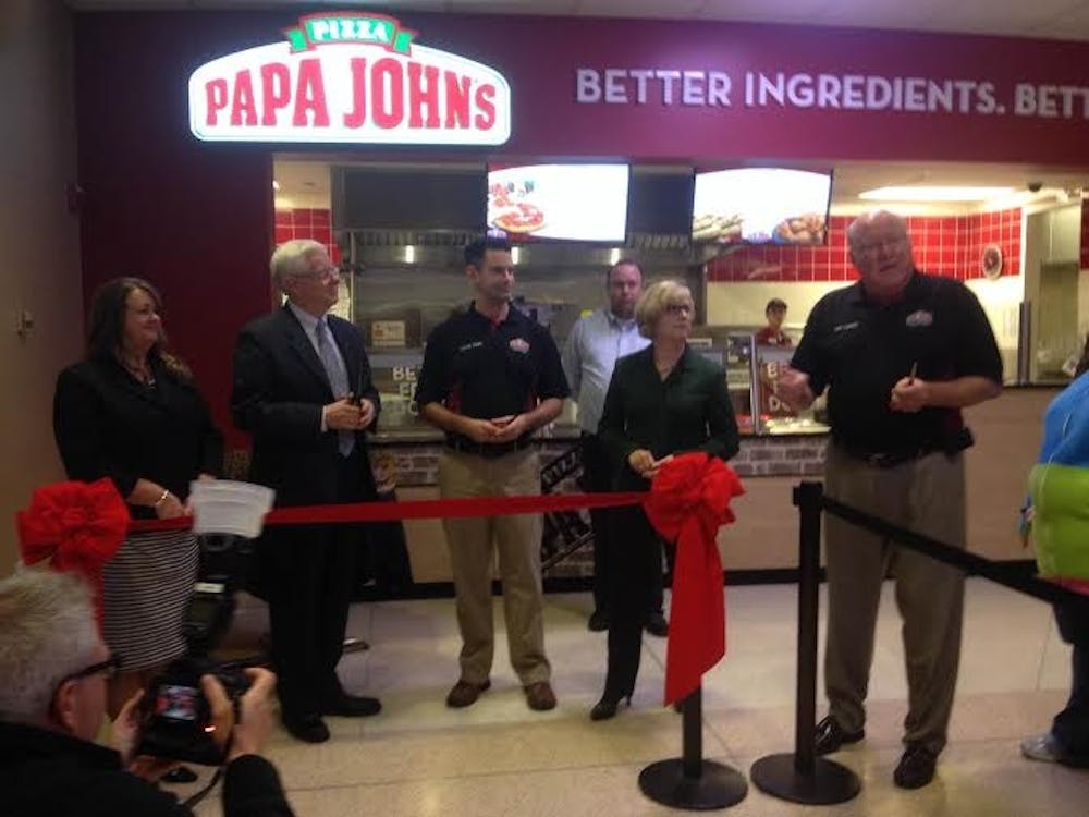 <p>President Ferguson attended Friday's ribbon cutting of the Papa John's in the Atrium. The restaurant sold 1,300 pizzas on its first day. <em>DN PHOTO TAYLOR WEDDLE</em></p>