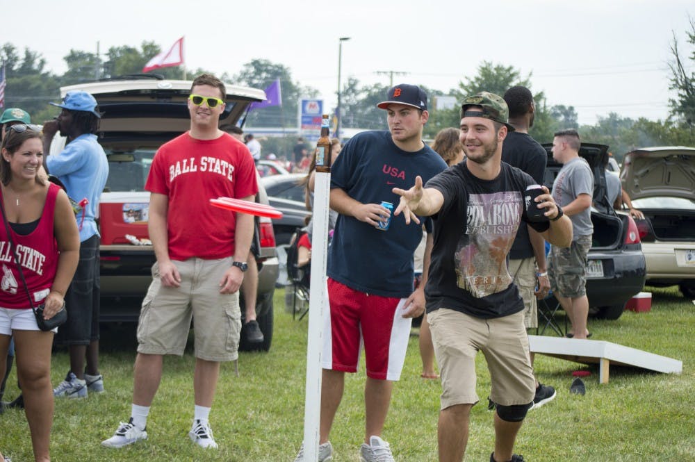 Senior marketing major, Brad Freidburger plays "beersbee" before the football game against Colgate on Aug. 30 at the tailgate. DN PHOTO ALAINA JAYE HALSEY