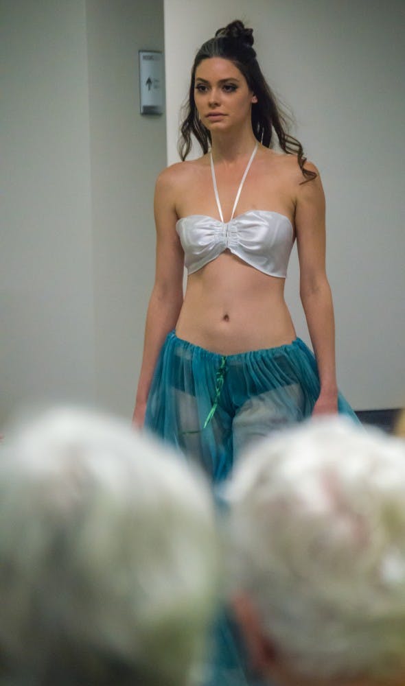 Family and friends watched the Fashion Design Soceity host a fashion show on April 1 in the Applied Technology Building. Since 1997, the organization helps fashion students develop their skills. Teri Lightning Jr., DN