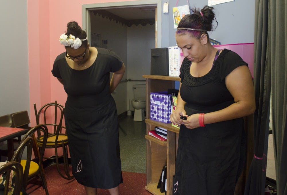Chilynn, 17, and Keyle, 16, put on their aprons June 27 at Pink Leaf Caf