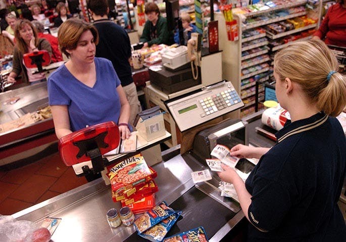 When at the checkout counter, watch the display screen for each item and its corresponding price. If you think you're being overcharged, speak up. Here, cashier Erin Travis scans coupons from Heather Sokol at a Marsh Supermarket in Westfield, Indiana. (Antonio Perez/Chicago Tribune/MCT)