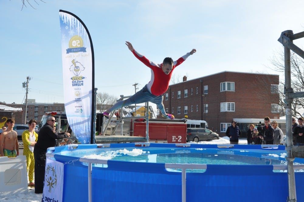 A volunteer belly flops into a pool of cold water at the annual Special Olympics Indiana Polar Plunge Saturday, Feb. 2, 2019, at the L.A. Pittenger Student Center. This year's plunge raised an estimated $20,000, more than any other previous plunge at Ball State. Jacob Musselman, DN