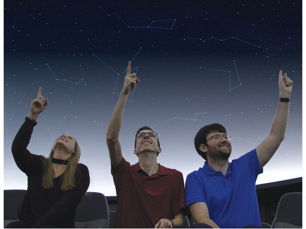 Brielle Tilson, graduate assistant in the Department of Physics and Astronomy, Kyle Koeller, junior astronomy major, and Daniel Brosser, second year master's student, sit in the Charles W. Brown Planetarium Nov. 19, 2019. Tilson, Koeller and Brossard are part of the planetarium's student staff. Jacob Musselman, DN Illustration; Freepik, graphic courtesy; Emily Wright, DN Illustration