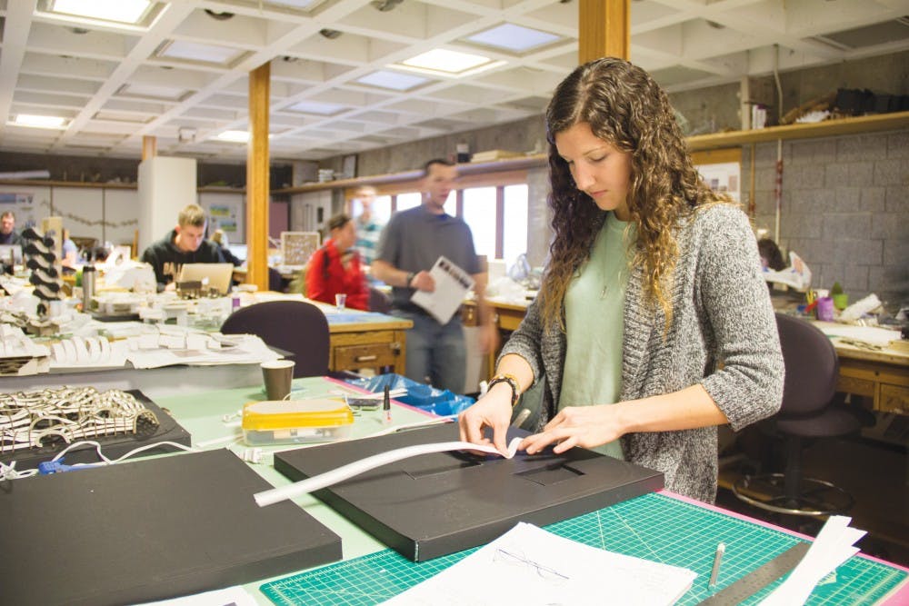 Denise Blankenberger, a sophomore architecture major, works on a model that she based on zebra stripes. Architecture students spend many hours working on their projects in the Architecture Building. DN PHOTO EMMA ROGERS